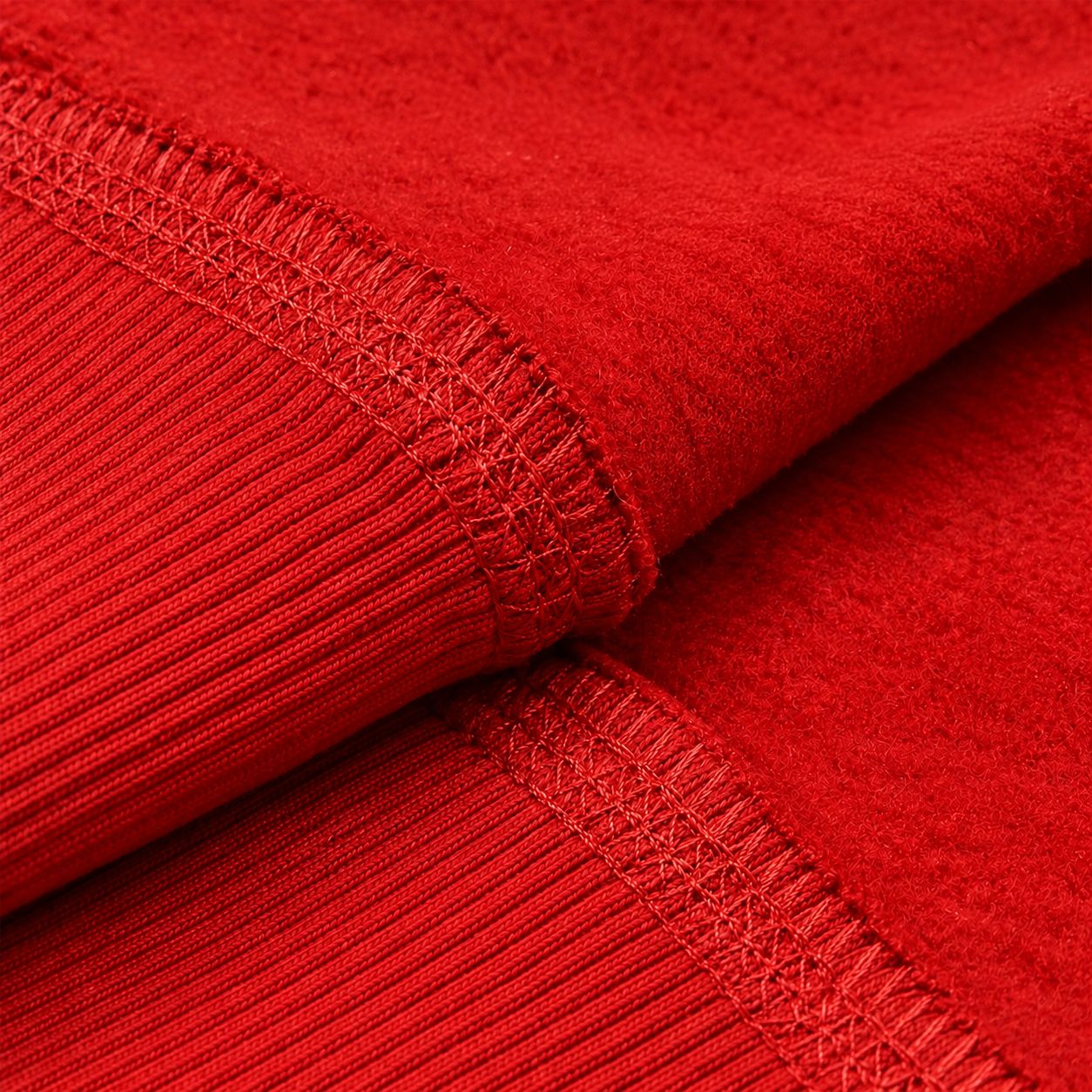Close-up of brushed fleece and cover stitching on a red hoodie